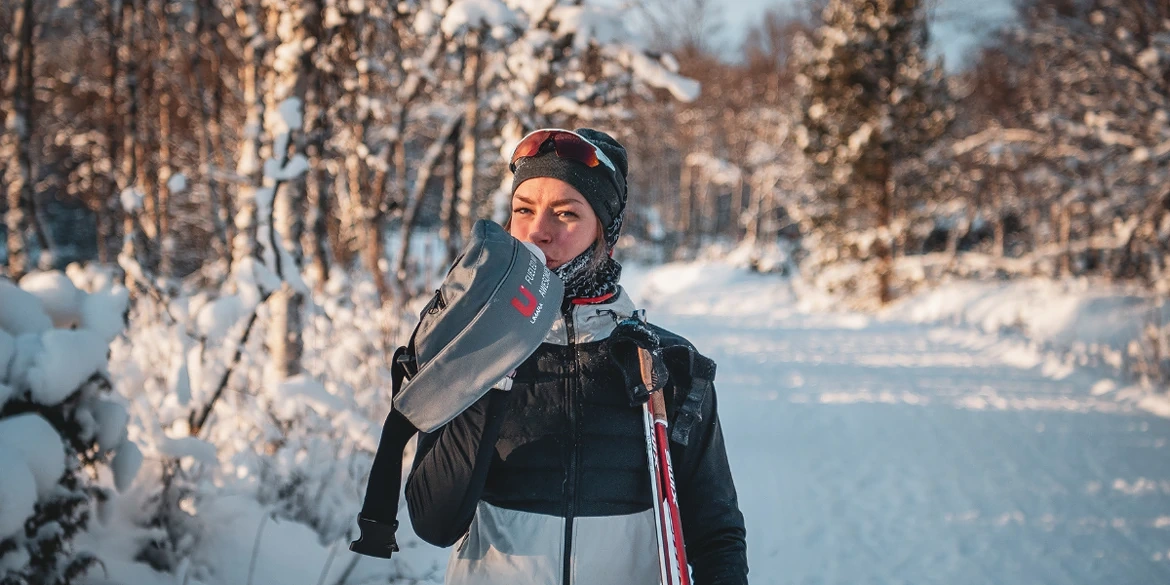 cross country skier drinking sports drink